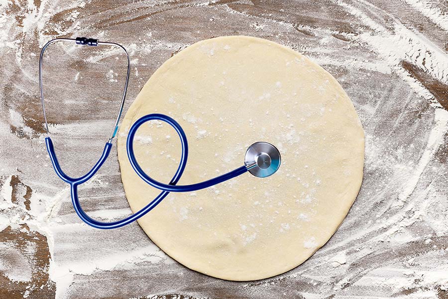 Image of stethoscope listening to pizza dough.