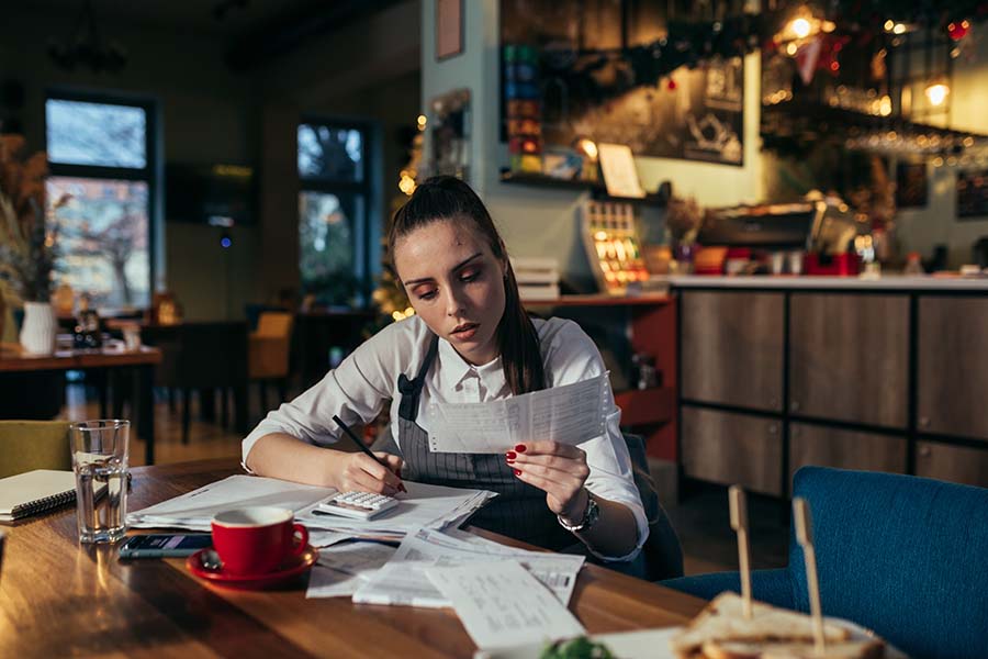 Image of restaurant owner or manager reading financial statements