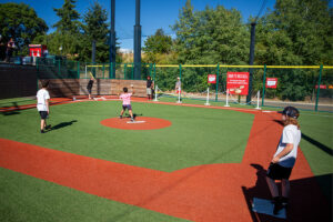 Image of families playing at Cheney Stadium during Farrelli's Pizza's 30th anniversary party on Aug. 11, 2025.
