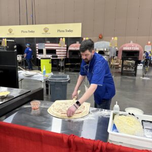 Chris Ostapenko of Slice on Broadway in Pittsburgh prepares his cheese pizza in the World’s Best Cheese Slice Championship at International Pizza Challenge at Pizza Expo in Las Vegas.