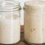 Image of two glass jars with sourdough starters at different hydration levels.