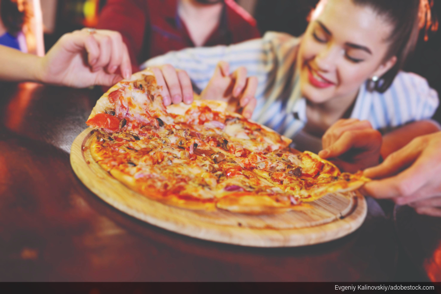 pulling slices of pizza