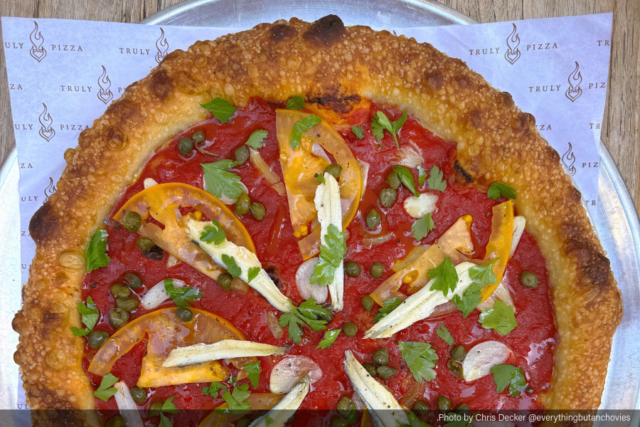Pizza Puttanesca featuring heirloom tomato, capers, shaved garlic, fresh white anchovy and fresh Italian parsley by Chris Decker, Truly Pizza, Dana Point, California